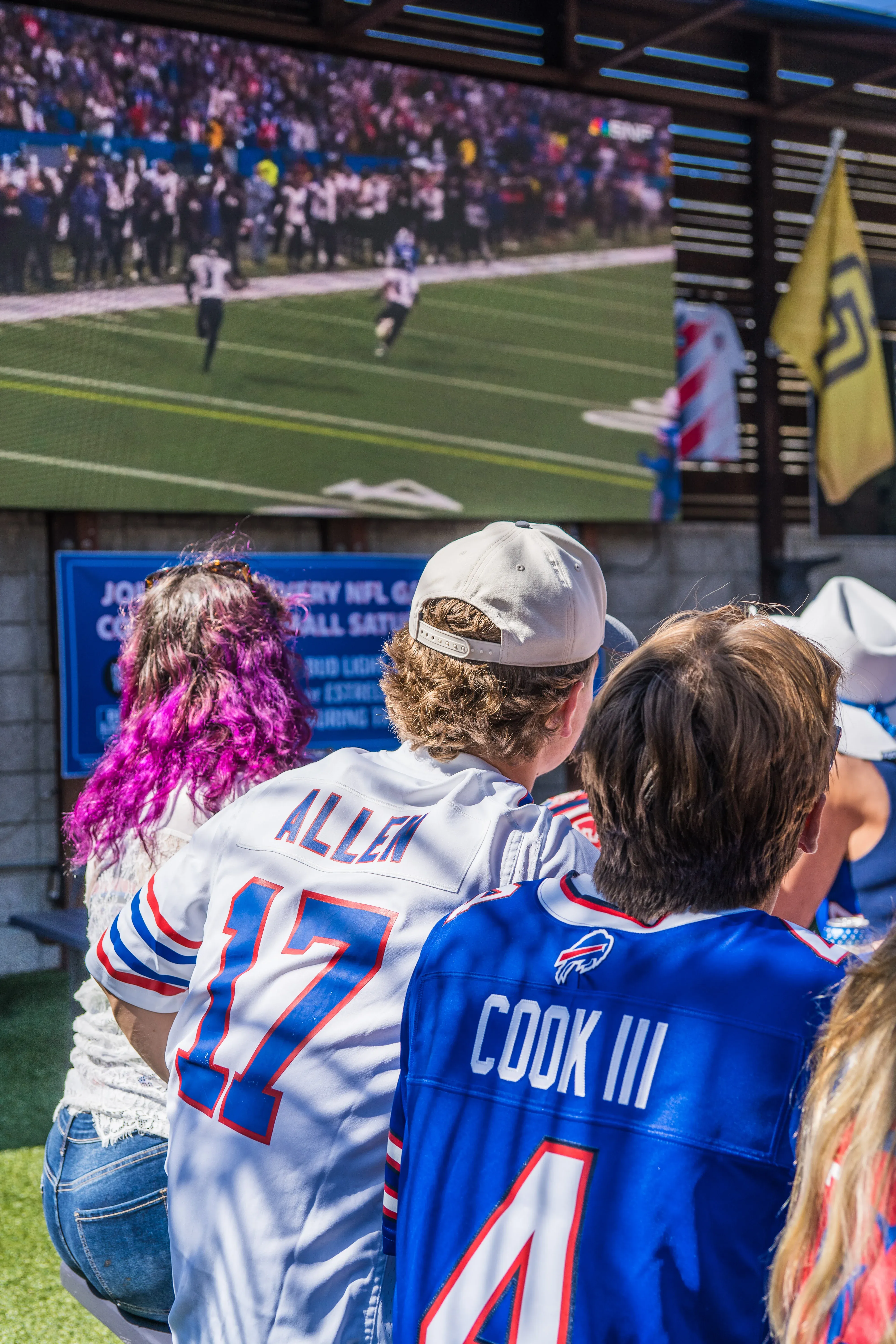 Buffalo Bills fans watching football on the outdoor LED screen at Park 101 in Carlsbad Village