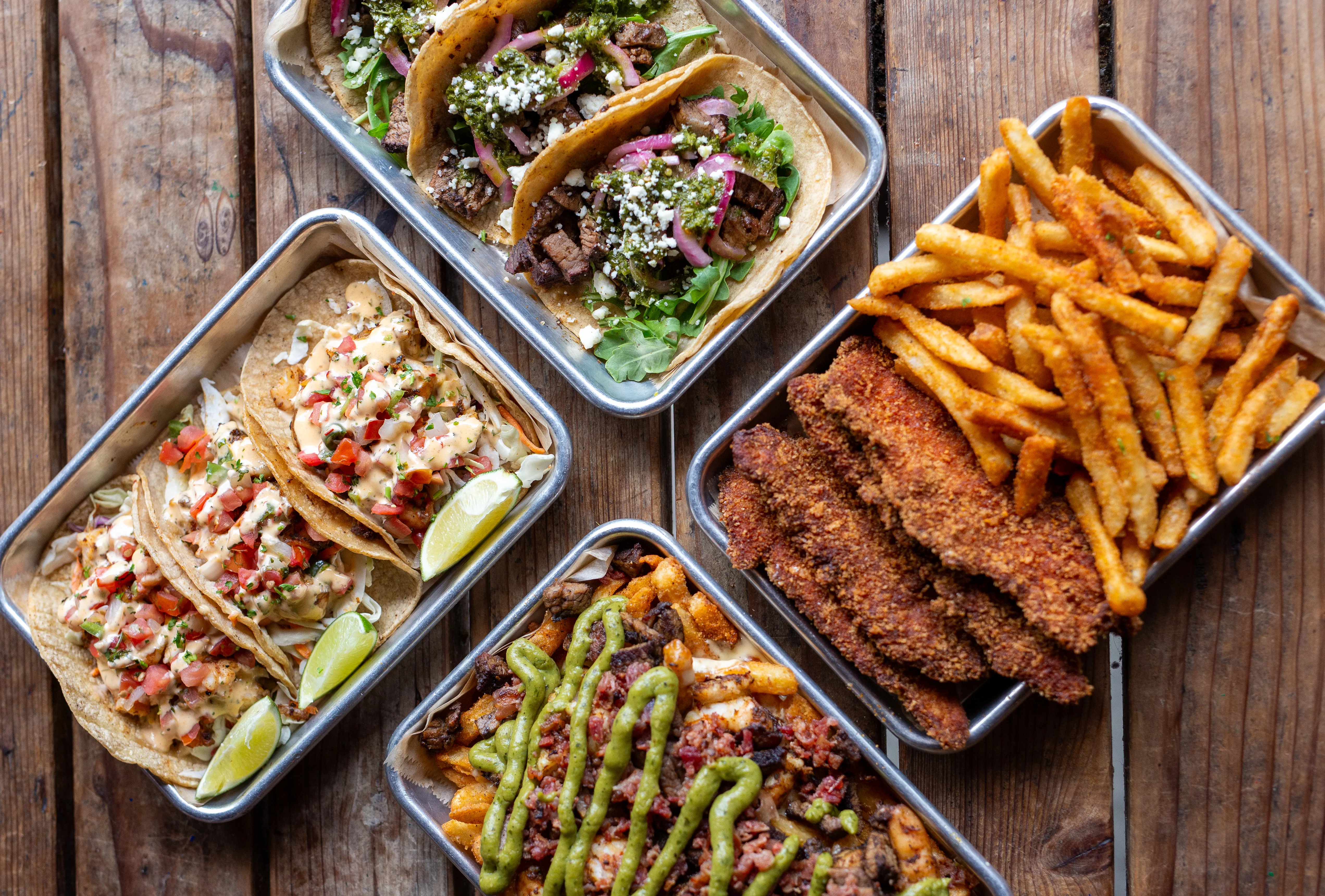 A spread of wood-smoked BBQ dishes at Park 101 Carlsbad
