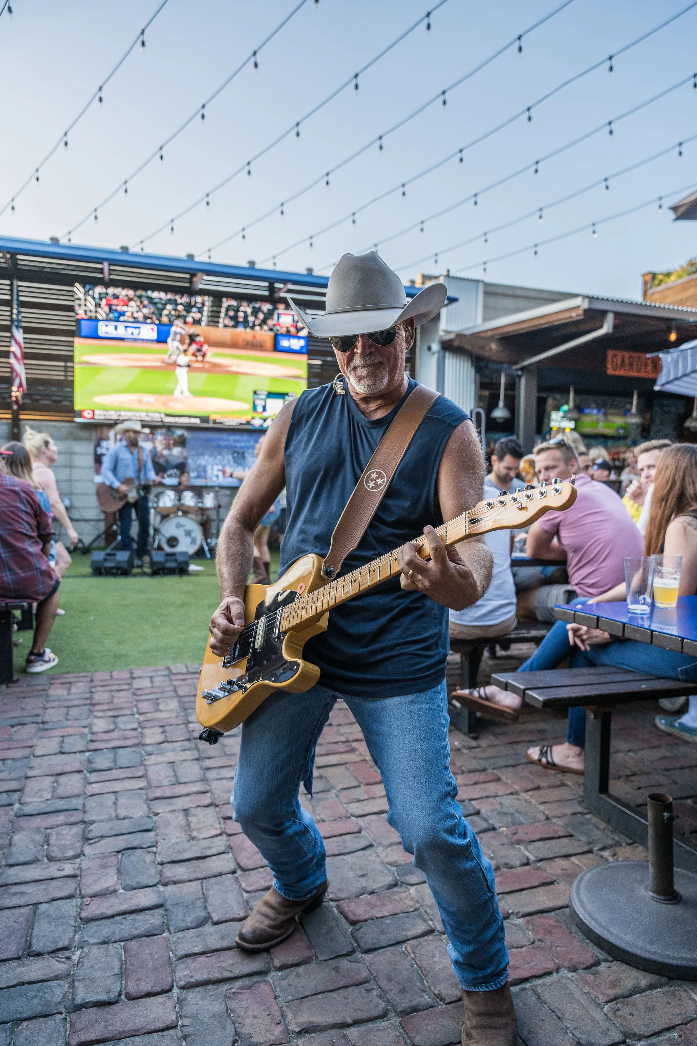 Country guitarist performing live at Park 101 Carlsbad with the LED screen and crowd behind him
