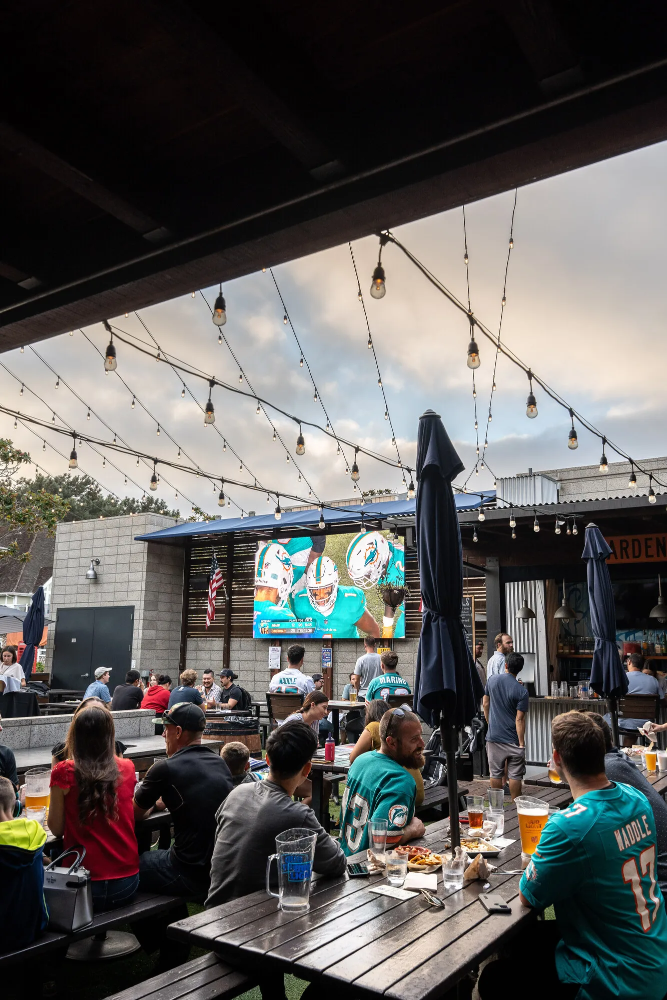 Group gathered around screens at Park 101 Carlsbad