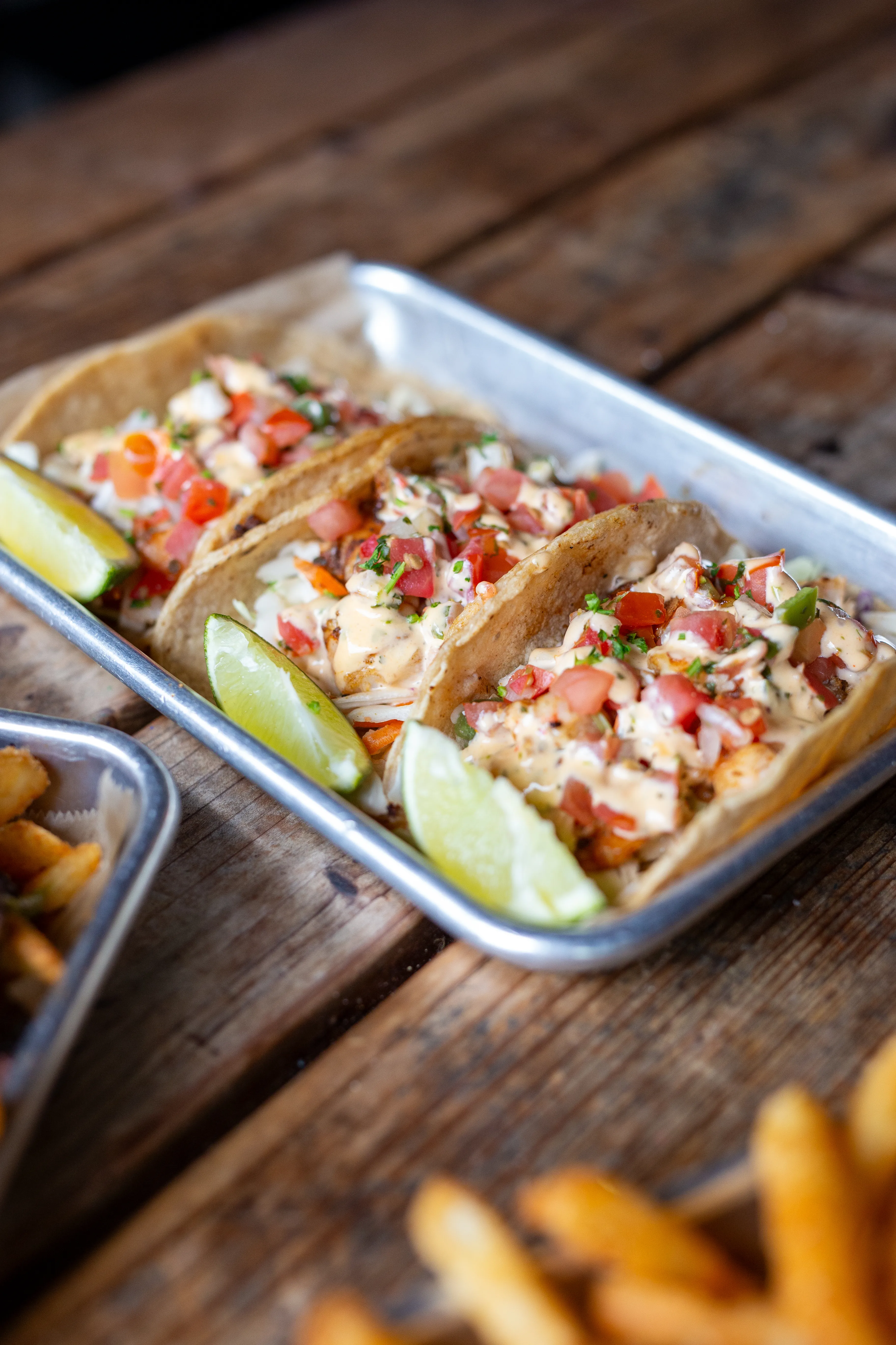 Shrimp tacos with chipotle sauce and lime at Park 101 Carlsbad