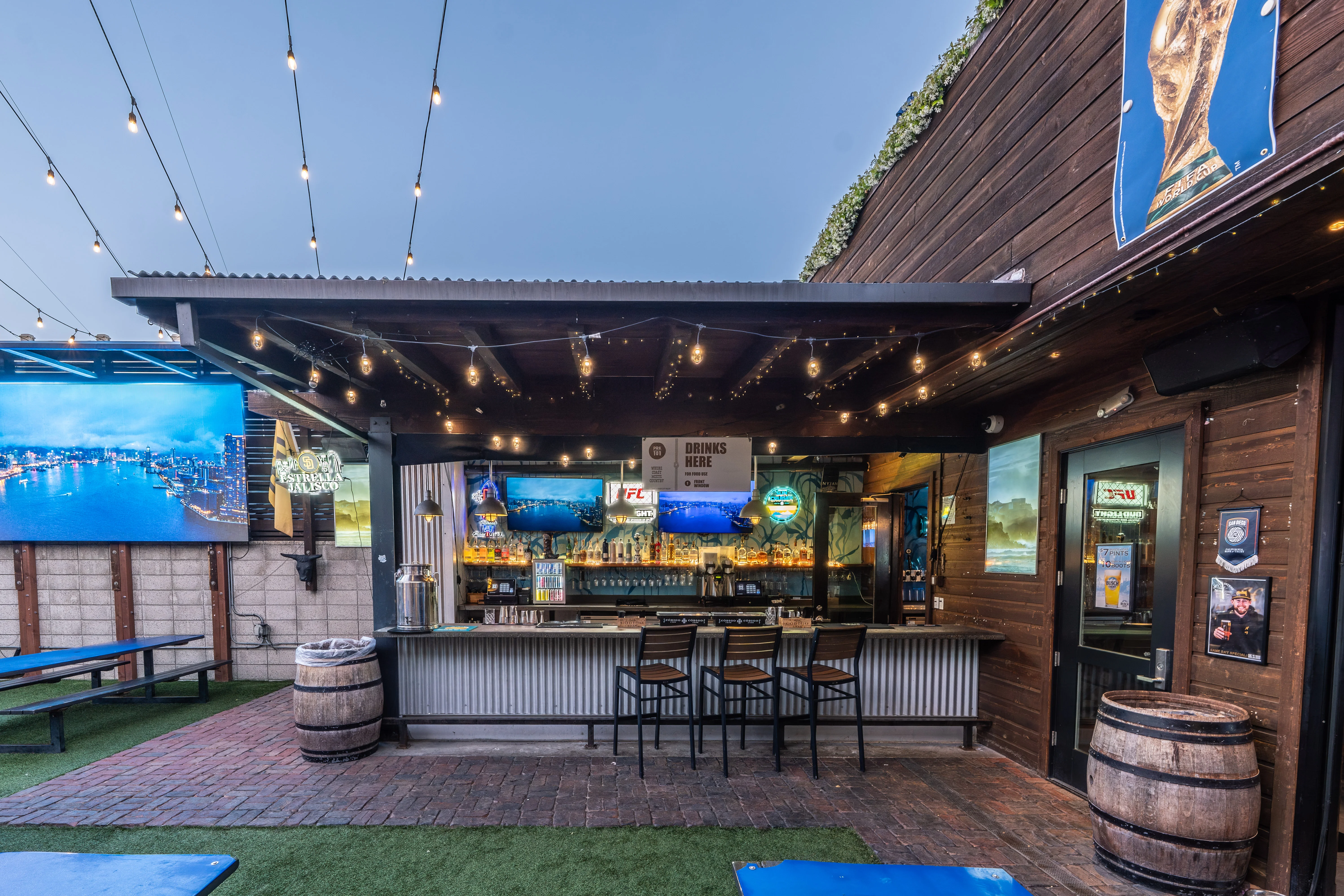 Park 101 outdoor bar with LED screen and string lights in Carlsbad Village
