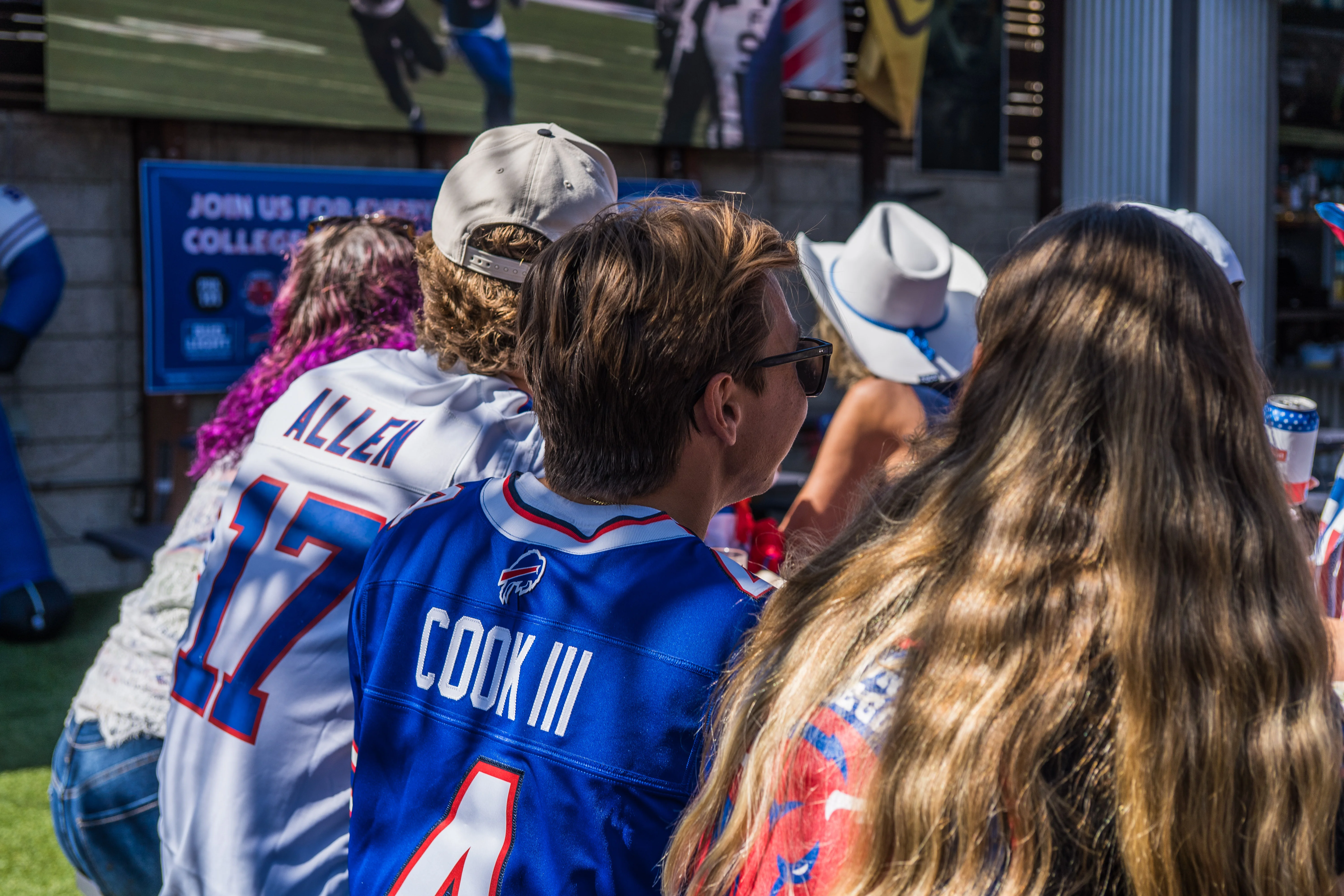 Packed crowd watching Buffalo Bills game on the outdoor LED screen at Park 101 Carlsbad